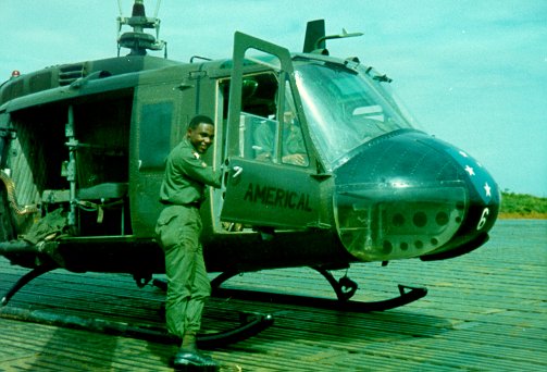 This is AMERICAL-6, the aircraft used General Koster, Division Commander.  You might notice the creature comforts, such as the thick seat cushions in the cargo/passenger area.   This gentleman is Sgt. Dickerson, the gunner for this aircraft.  The crewchief was Bill Lucas and the aircraft commander was Mr. Mark How.