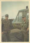 John Hastings and Dwane Connell standing beside one our Huey's repainted with the AMERICAL division name on the door.